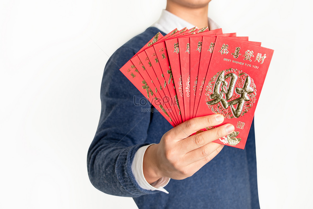 hand giving money in red envelope over white, Stock image