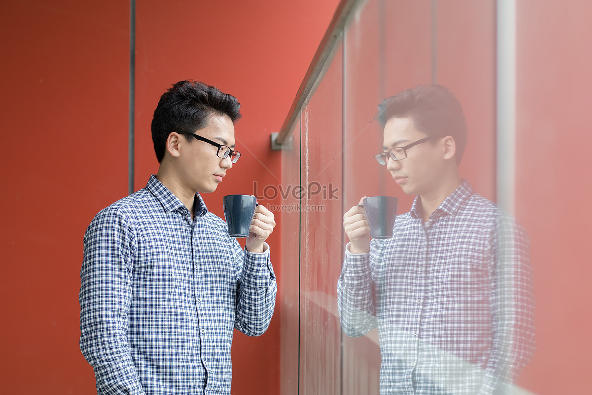 A Young Man Who Drinks Coffee In Front Of The Window Picture And HD ...