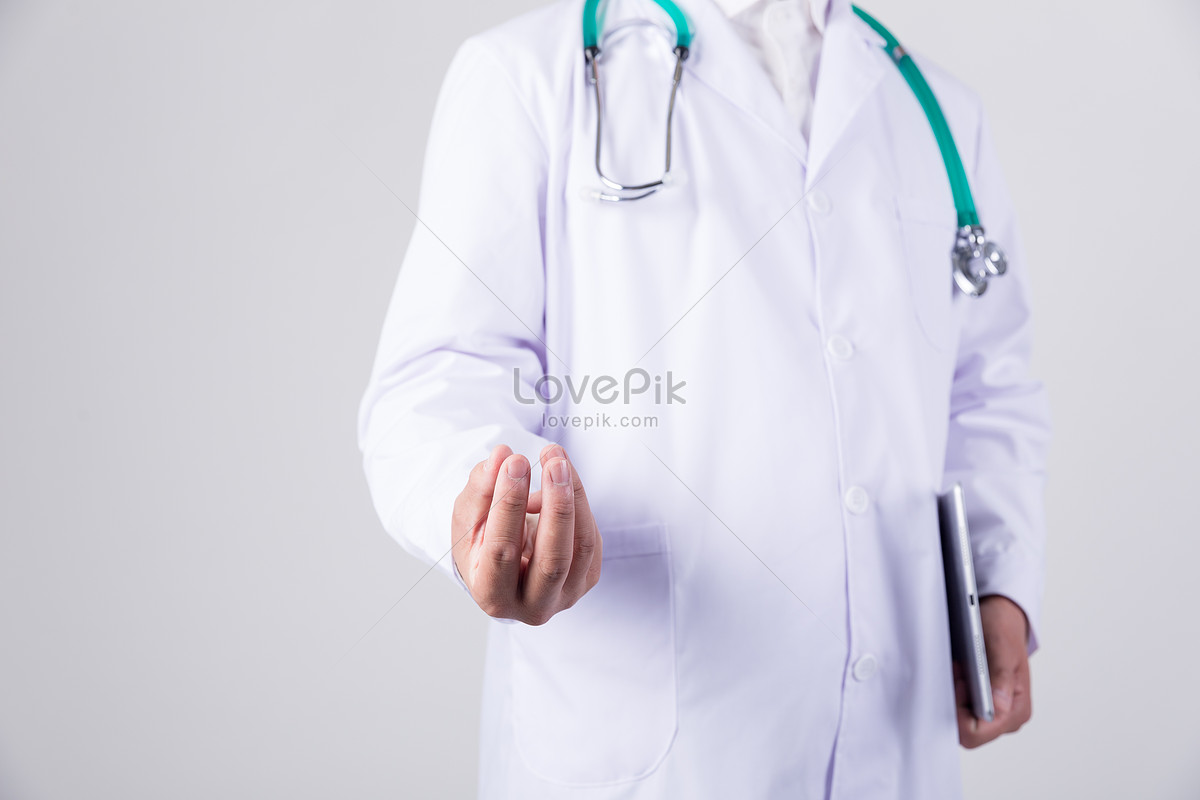 Doctor with a marker in hand, close-up. A nurse in a medical uniform writes  with a pen, blue background Stock Photo - Alamy