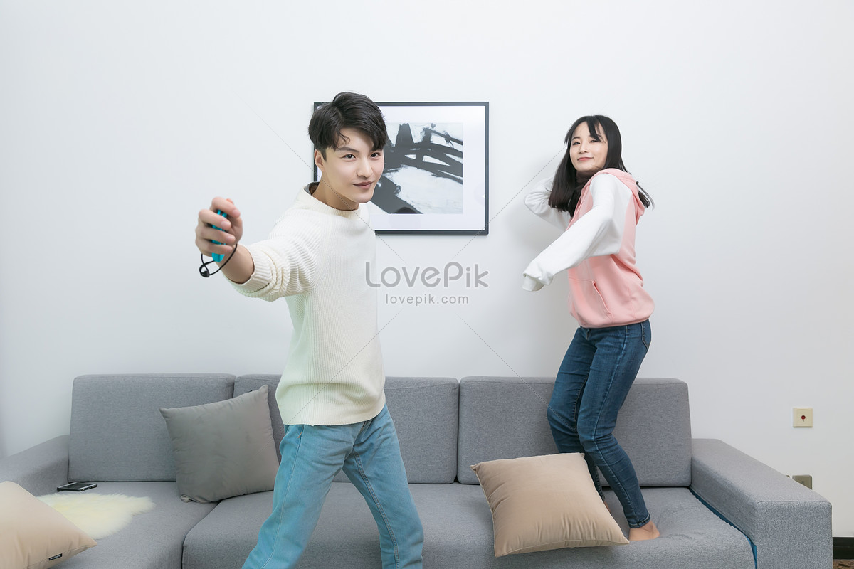 A Couple Playing Games Together In The Living Room Picture And HD Photos |  Free Download On Lovepik