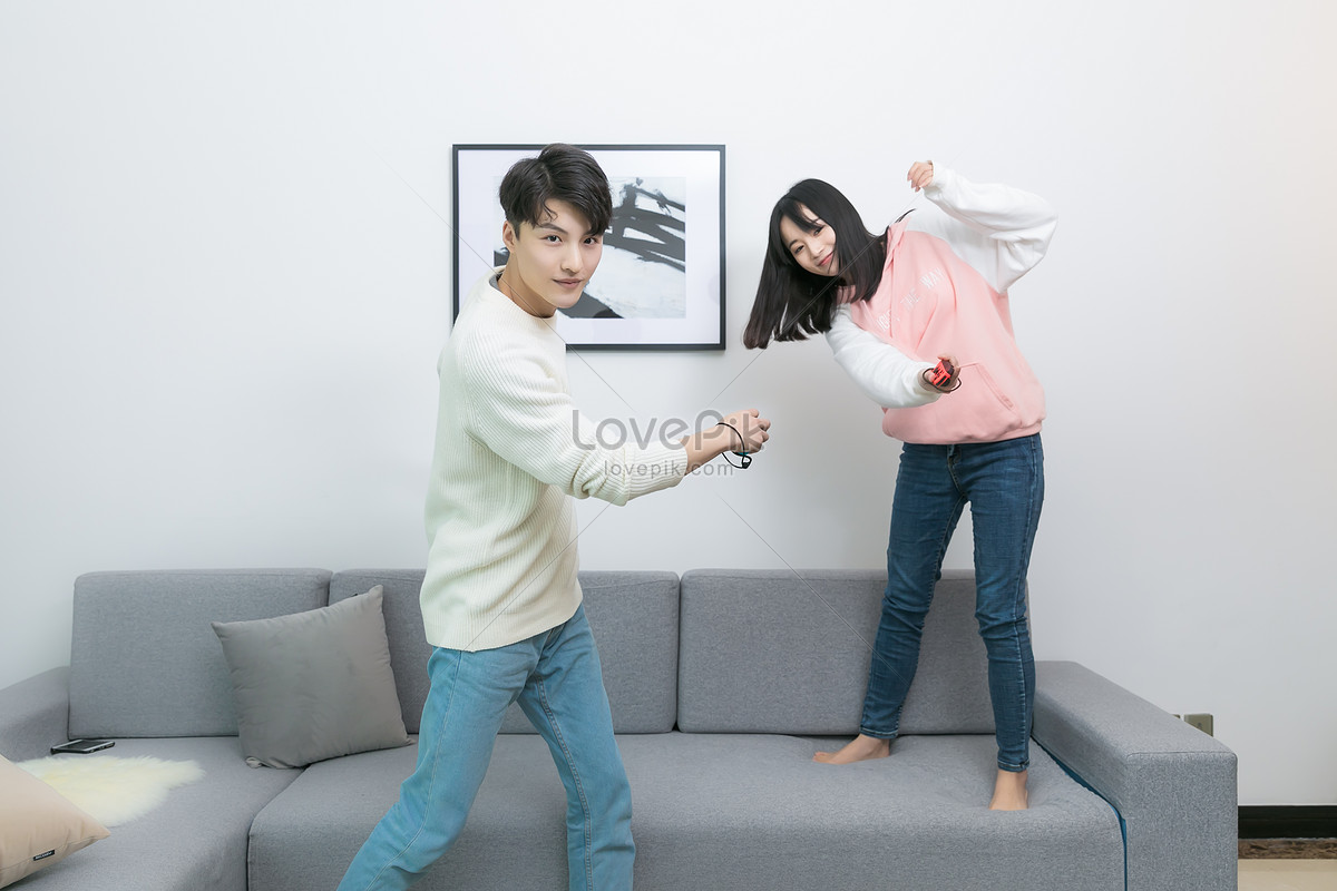 A Couple Playing Games Together In The Living Room Picture And HD Photos |  Free Download On Lovepik