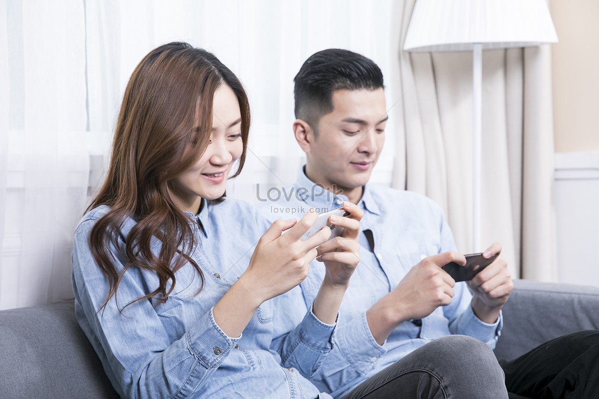 Пари телефон. Couples Play mobile Phones together. Couples Play mobile Phones together at Home. Husband and wife are watching mobile Phones together.