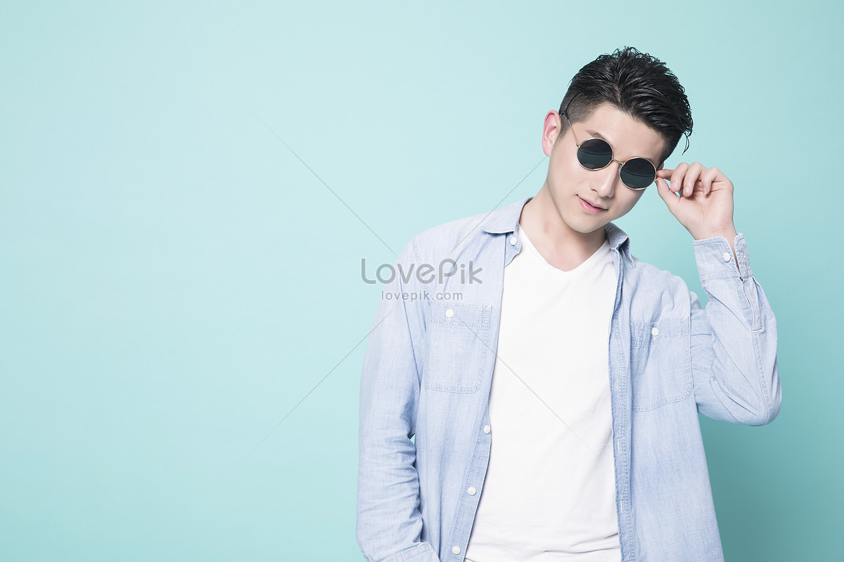 Attractive Young Male Model Posing Outdoors In Blue Shirt And Sunglasses  Stock Photo, Picture and Royalty Free Image. Image 16866753.