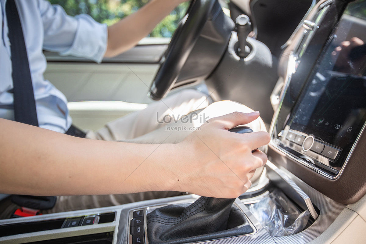Photo of Person hand on a car gear stick