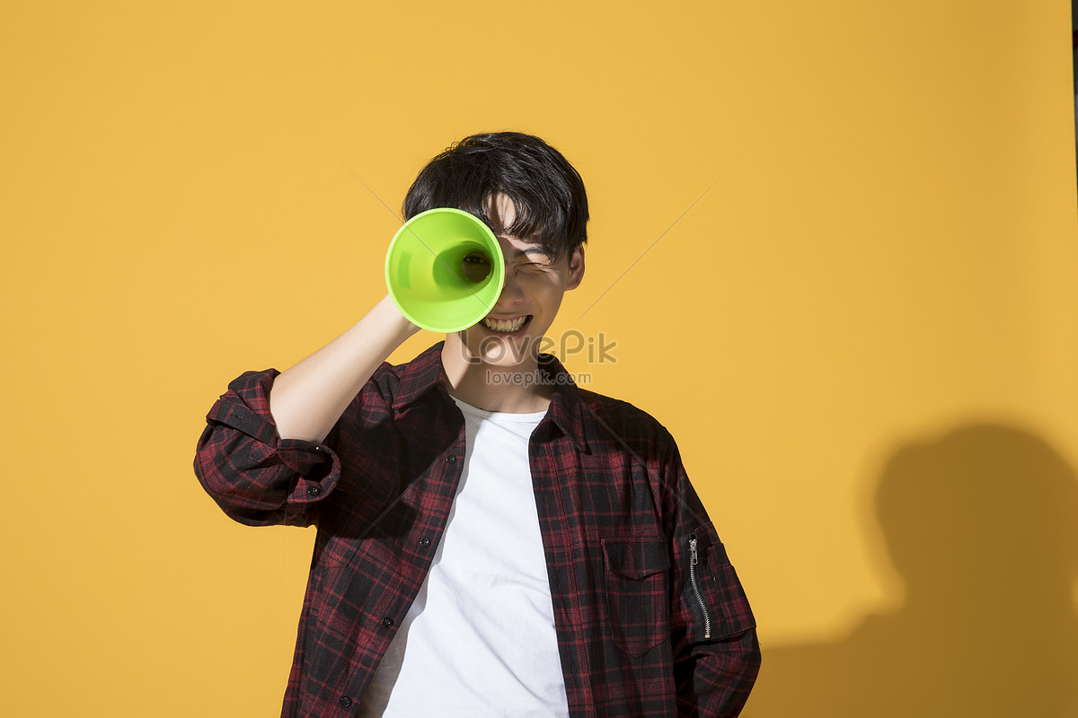 Young man with a Horn. Speaker man photo.