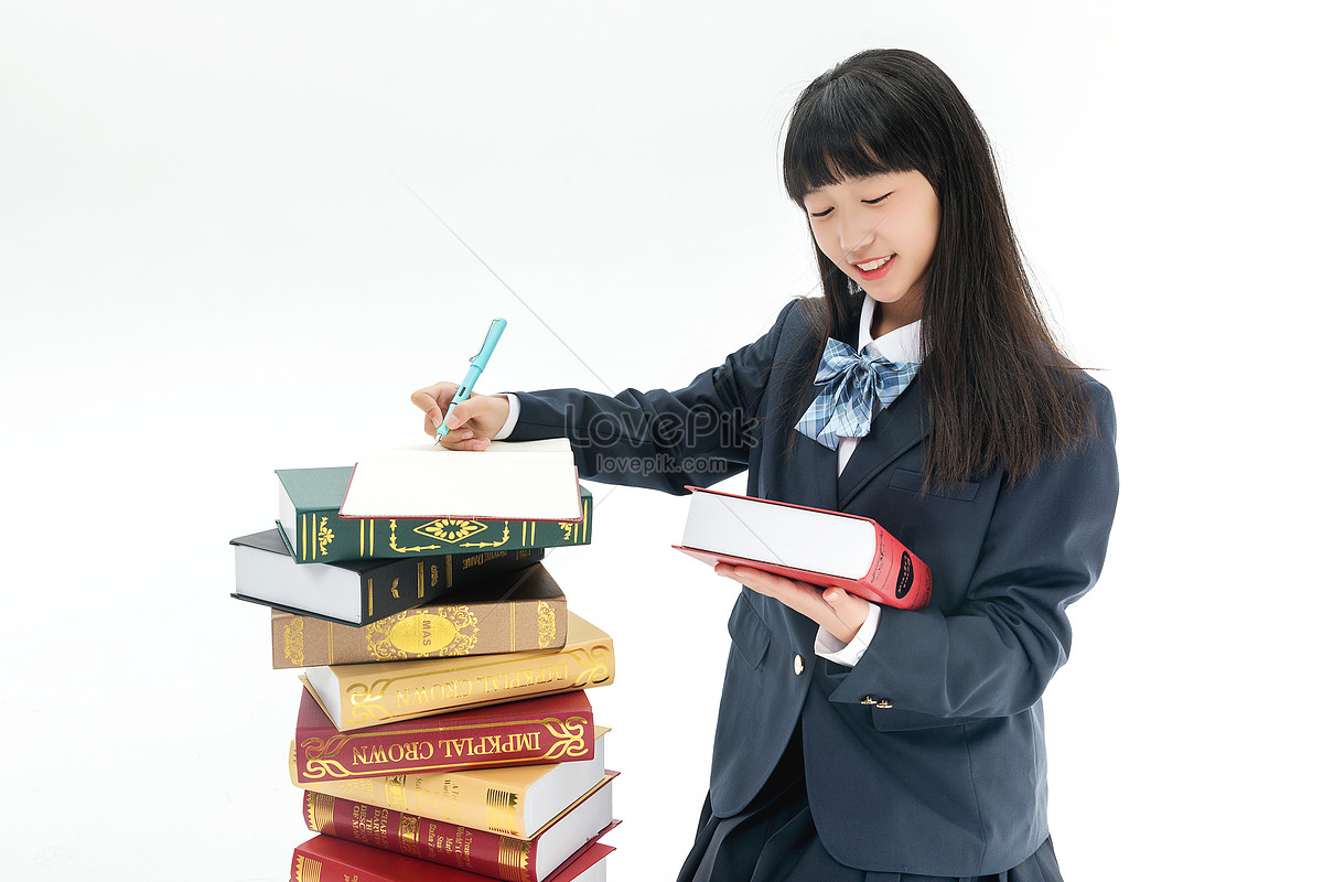 Female students write their homework by books, and homework, book, pretty girl HD Photo