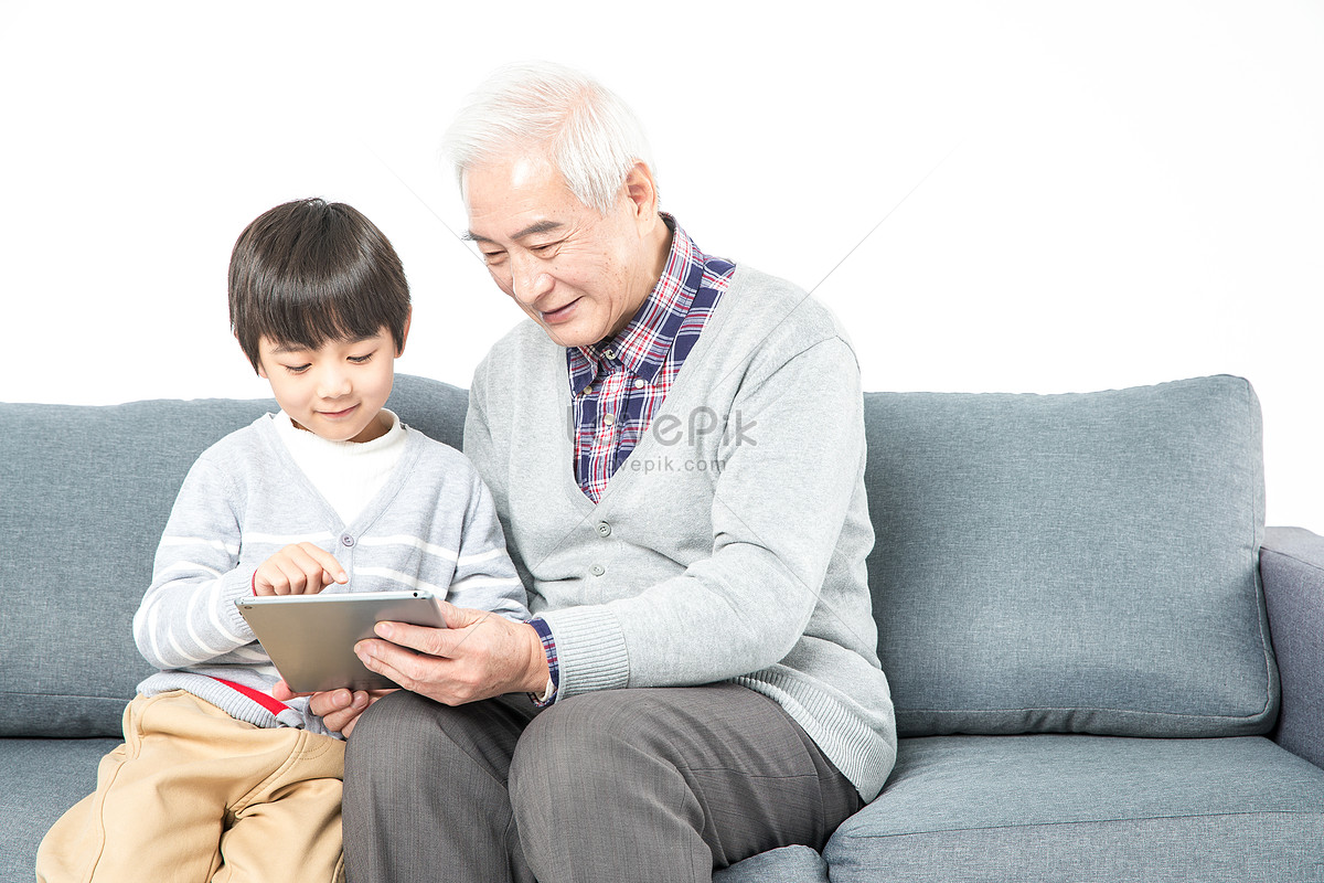 Grandfather And Grandson Use Tablet Computers On The Sofa Picture And