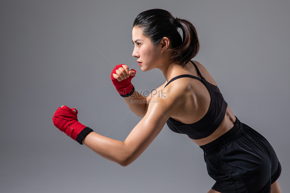 young and fit female fighter posing in combat poses - Stock Image -  Everypixel