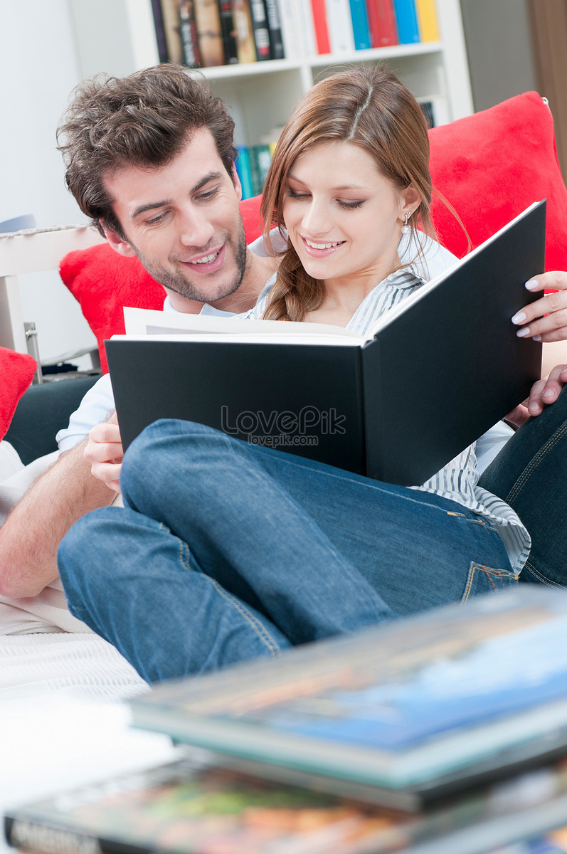 A Couple Reading A Book Together On The Sofa Picture And HD Photos ...