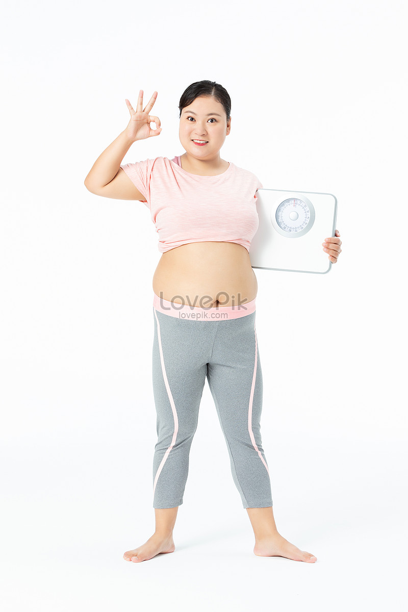 Large girl with weight scale hi-res stock photography and images