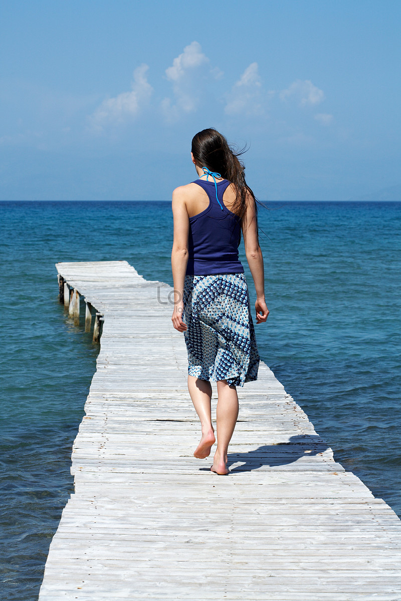 Young athletic woman standing on a pier stock photo