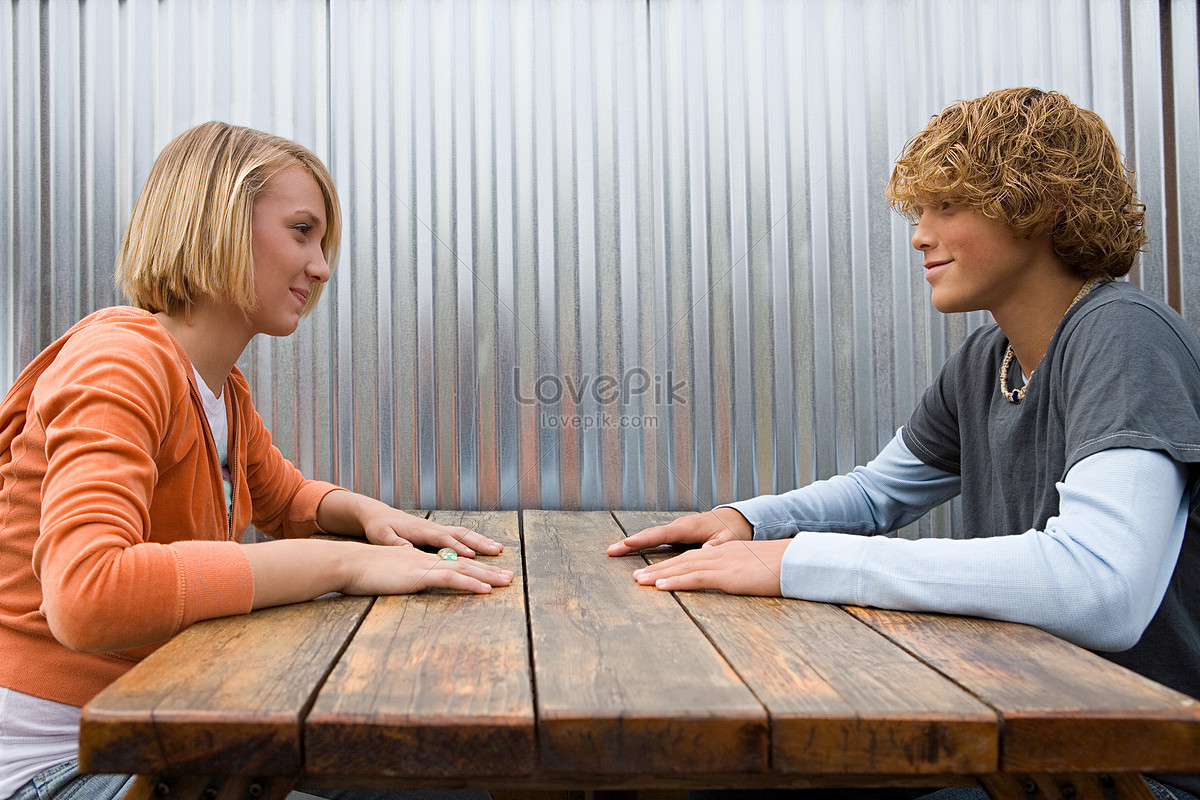 A Young Couple Sitting Face To Face Picture And HD Photos | Free Download  On Lovepik