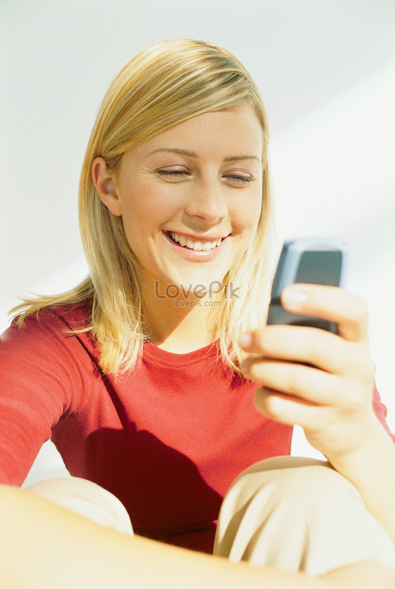 Woman Looking At Mobile Phone Smiling Picture And HD Photos | Free Download  On Lovepik