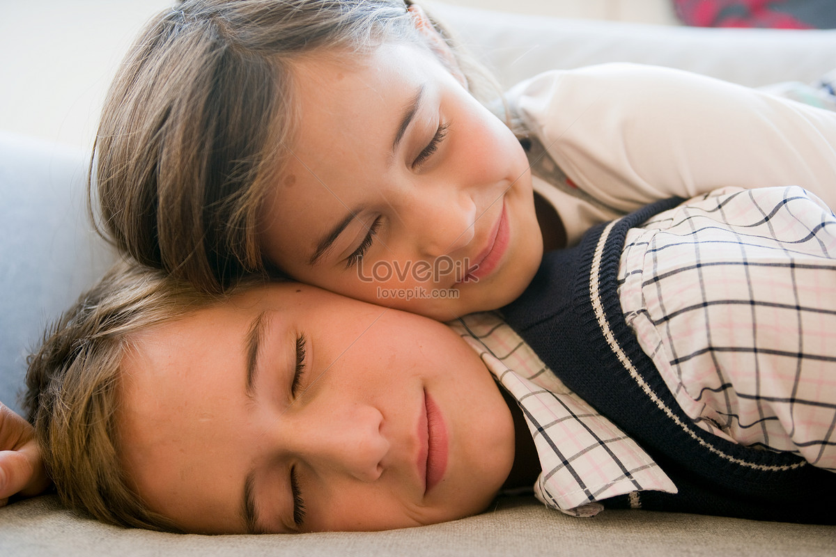 Two Children Sleeping Close To Each Other Picture.