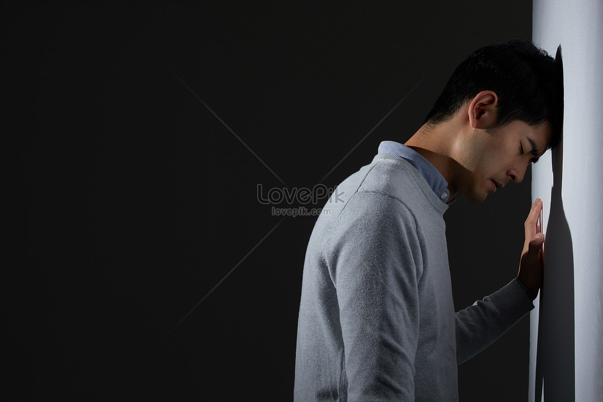 Young man suffering from flank pain on grey background Stock Photo