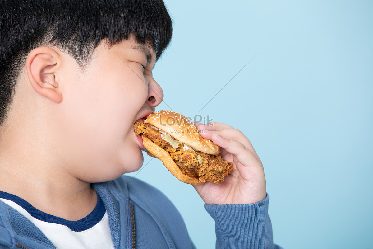 fat guy eating burger