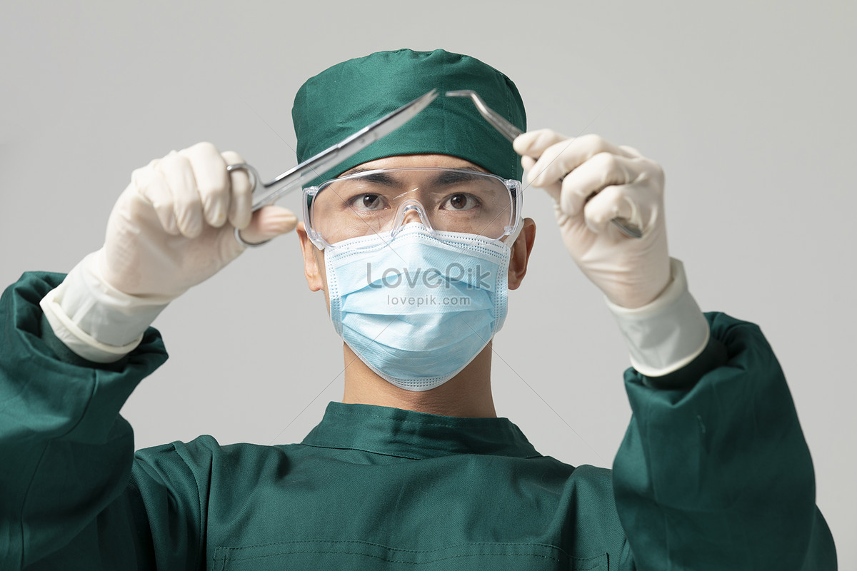 Fine Male In Surgical Gown Doctor Holding Surgical Scissors Picture And ...