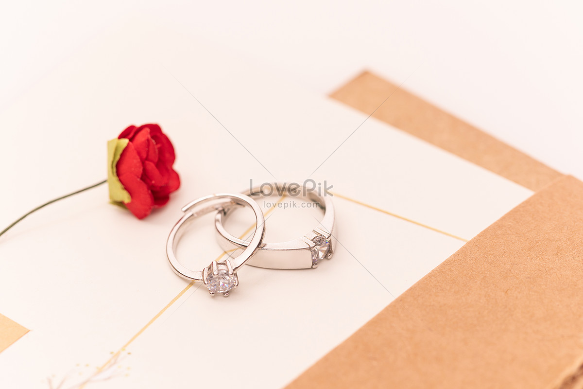 Close Up of Gold Wedding Rings or Engagement Rings on Wedding Invitation  Card Background. Stock Image - Image of celebration, card: 179928721