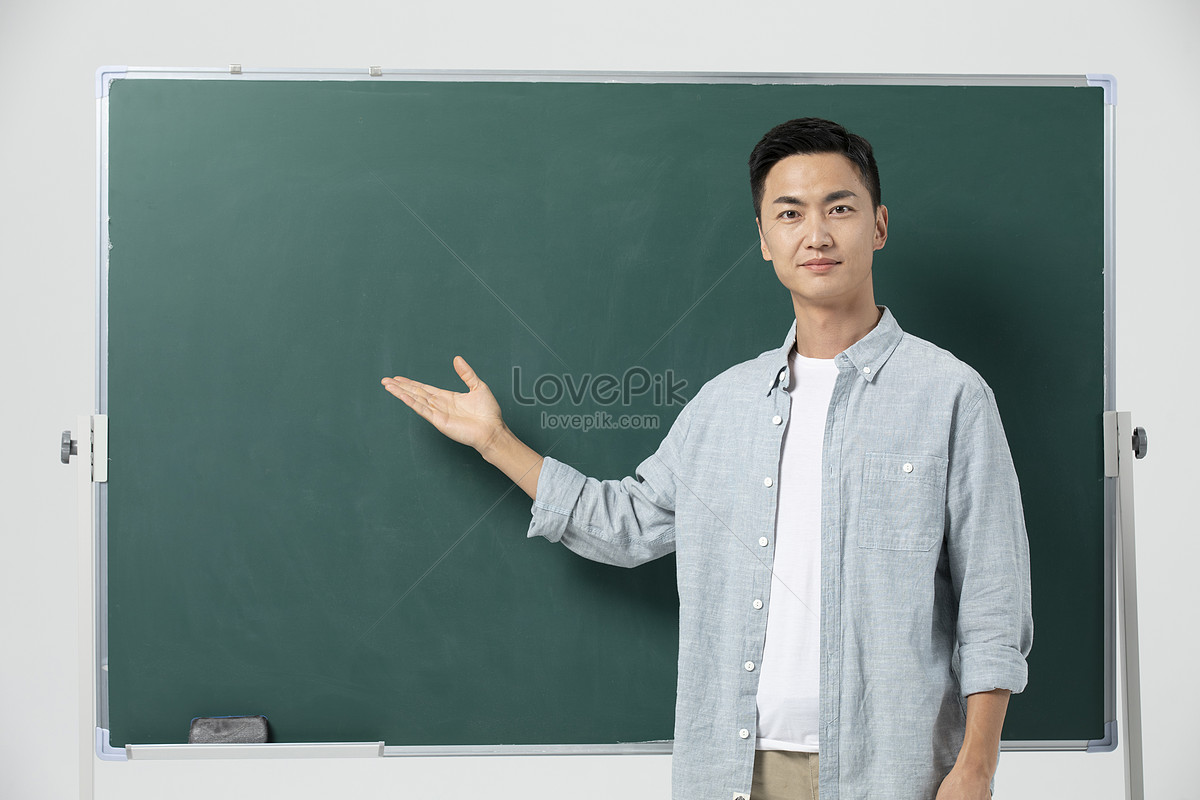 Male Teacher Giving Lecture In Front Of Blackboard Picture And HD ...