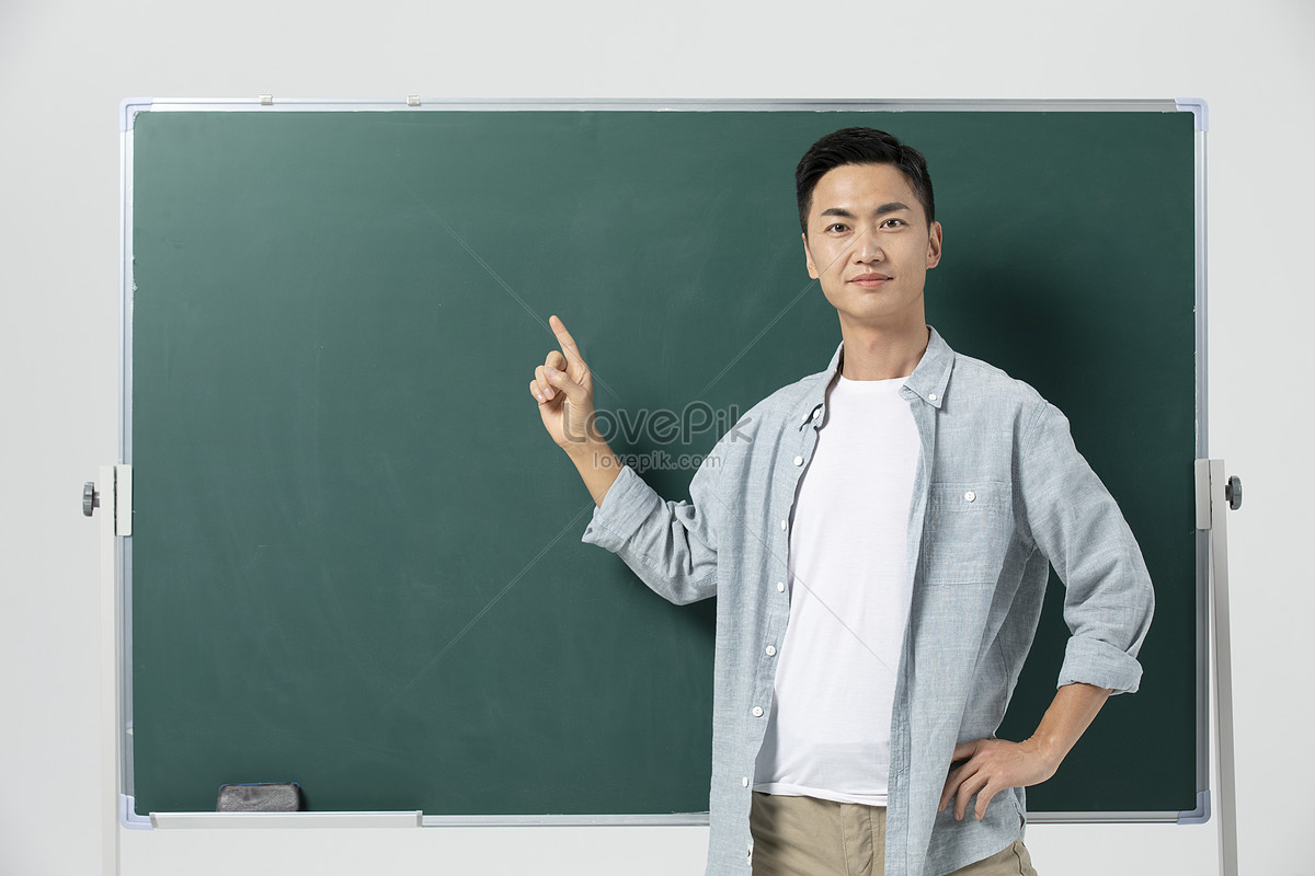 Male Teacher Giving Lecture In Front Of Blackboard Picture And HD ...