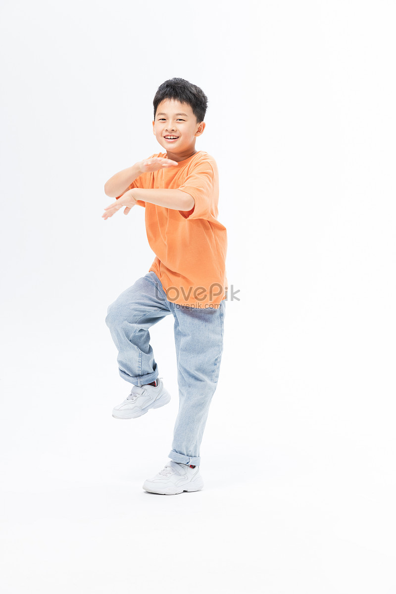 Schoolboy dressed in a stylish yellow sports suit and white sneakers poses  on a white background. Stock Photo by ©ddkolos.gmail.com 436374930