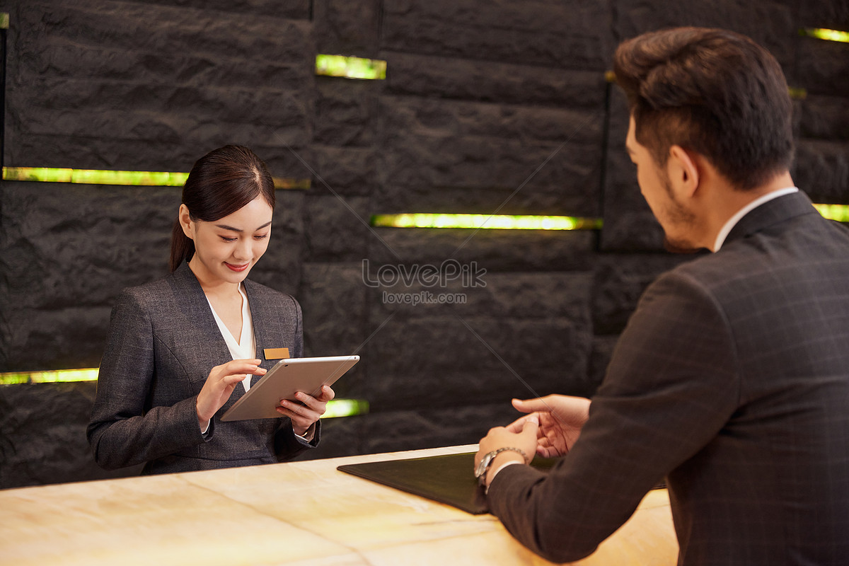 Hotel Front Desk Staff Check In For Customers Picture And HD Photos ...