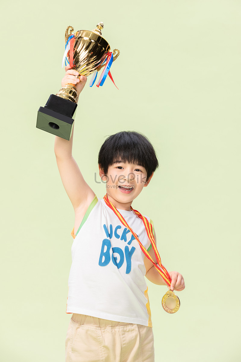 Little Boy Holds A Gold Medal Trophy Picture And HD Photos | Free ...