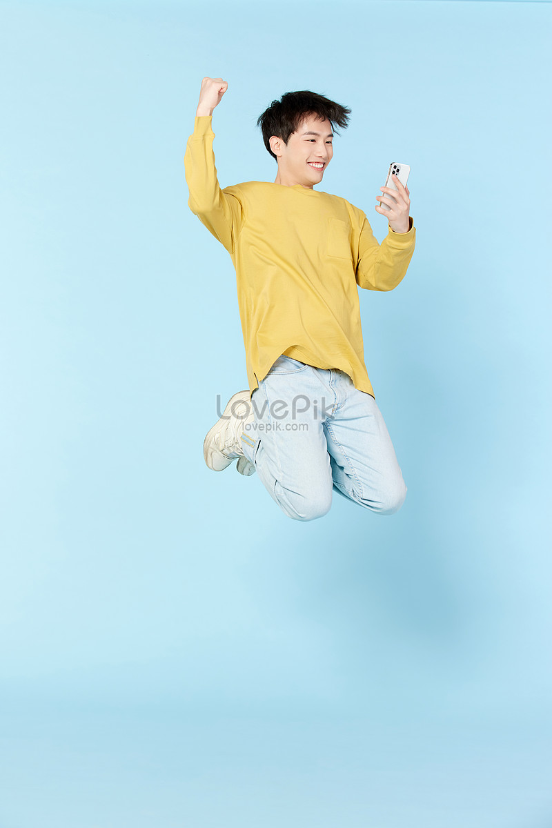 A Happy Young Baby Infant Jumping For Joy Stock Photo, Picture and