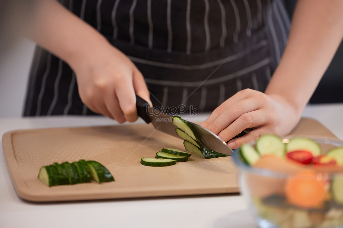 Close-up Of Woman's Hand Chopping Vegetables With Knife In Kitchen Stock  Photo, Picture and Royalty Free Image. Image 56706435.