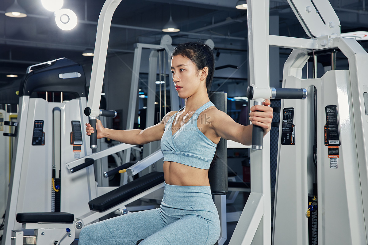 Female Fitness Enthusiast Using Butterfly Machine Picture And HD Photos