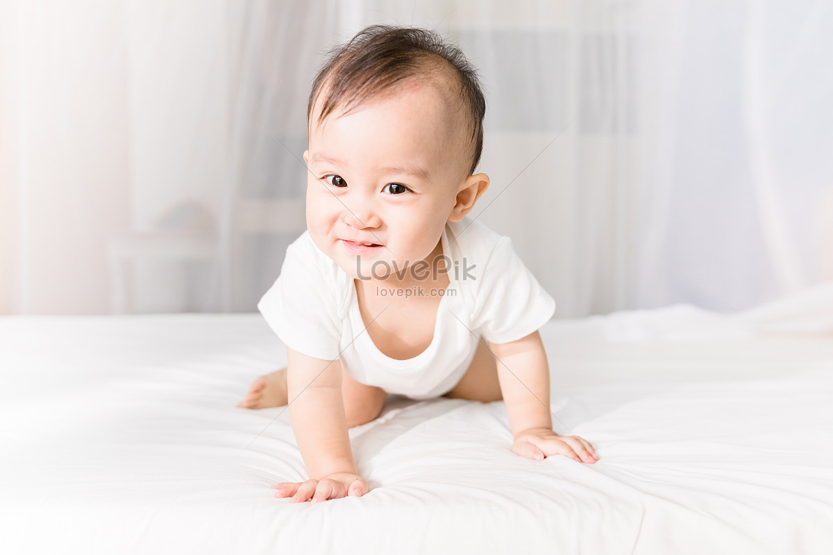 the-baby-is-sitting-on-the-bed-picture-and-hd-photos-free-download-on