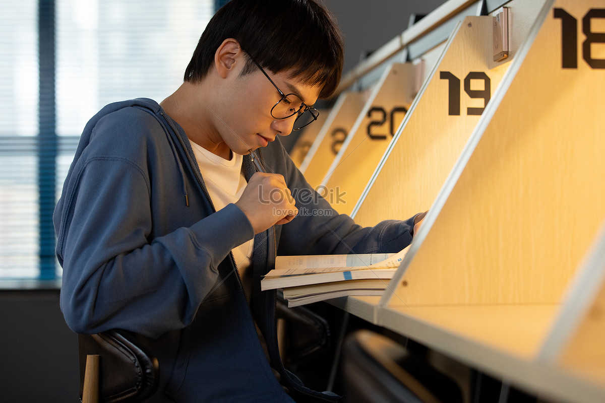 Male student reviewing homework in the morning study room Photo