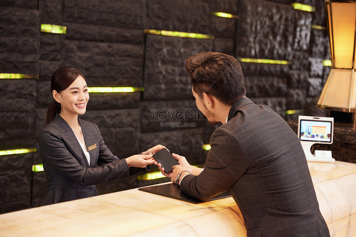 Hotel Front Desk Staff Check In For Customers Picture And HD Photos ...