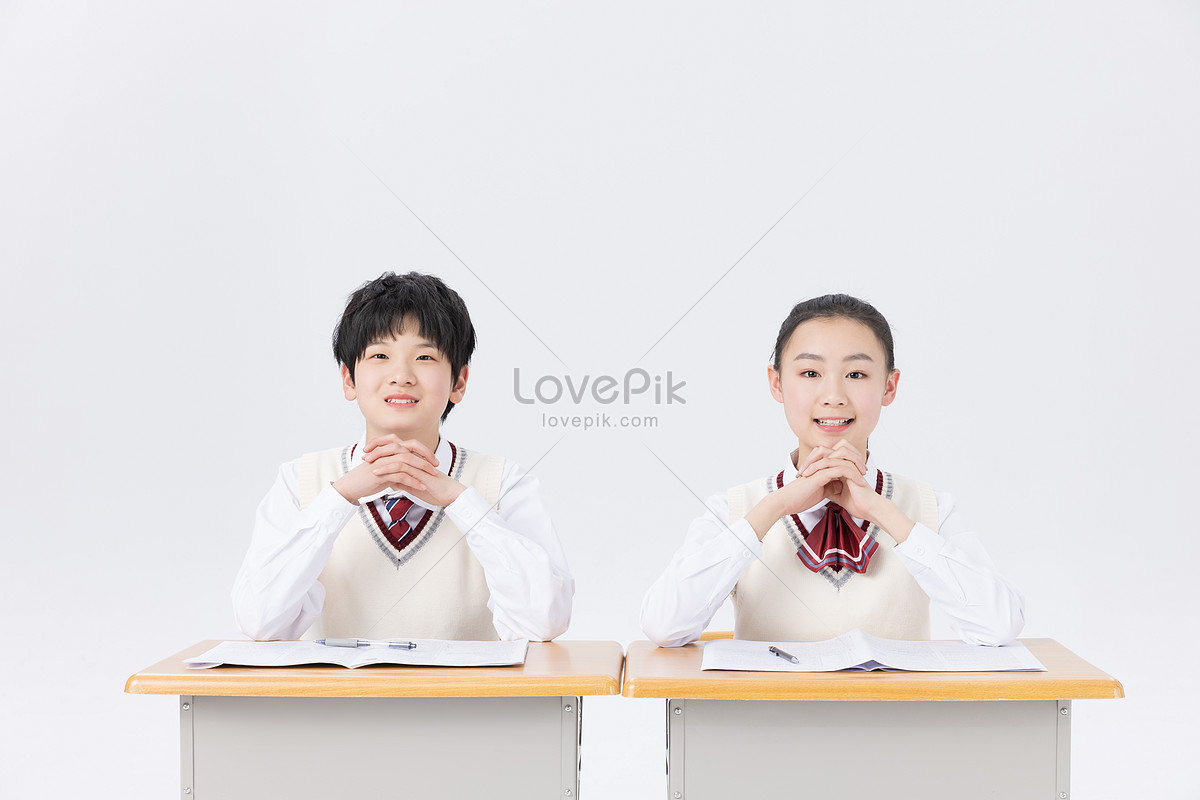 Middle school students in classroom studying and writing homework Photo