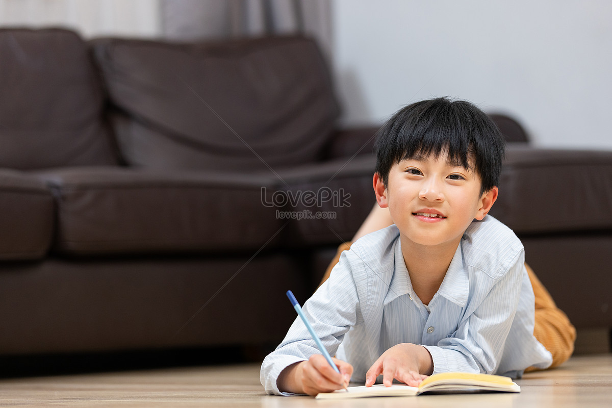 Little boy studying at home to do homework, homeschooling, and homework, book HD Photo