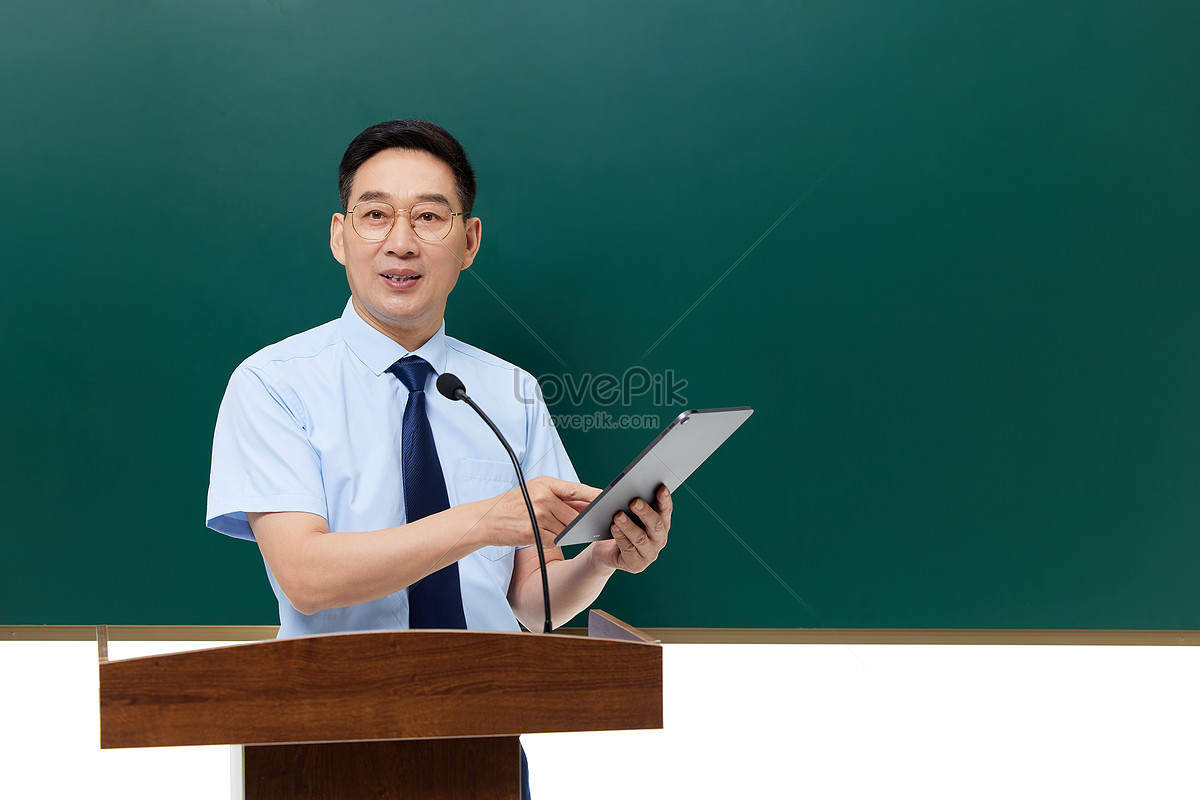 Male Professor Holding A Tablet Computer Stands On The Podium Picture ...