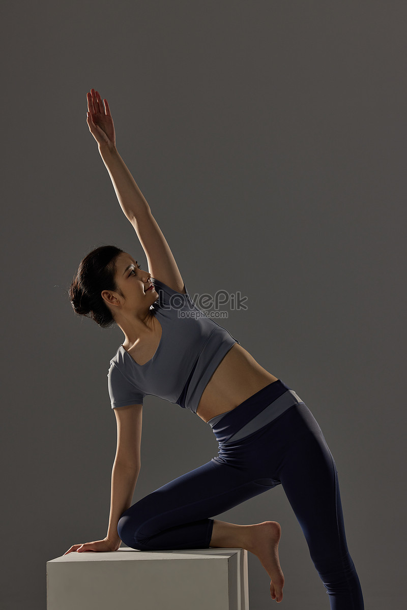 Premium Vector  Group of women doing yoga in a dark color yoga studio on  the background of a big city. banner
