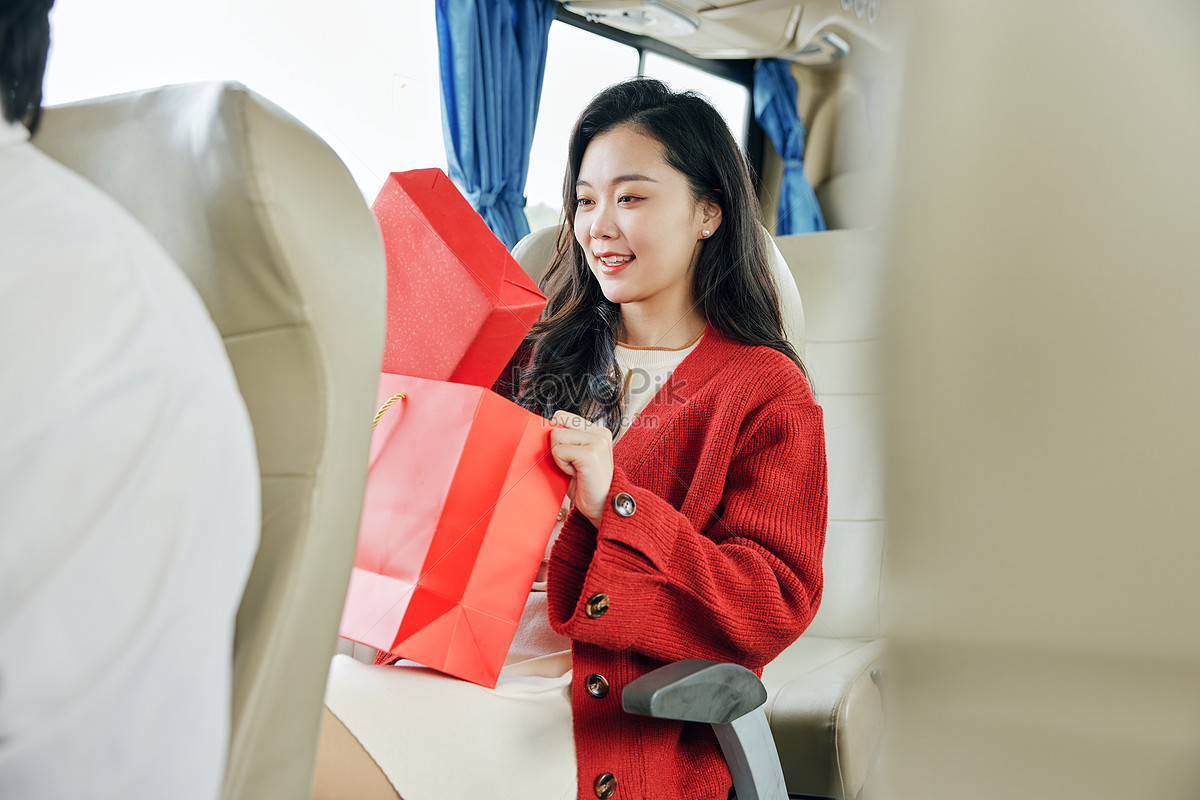 A woman returning home with a gift on the bus, cold, spring festival travel, bus HD Photo