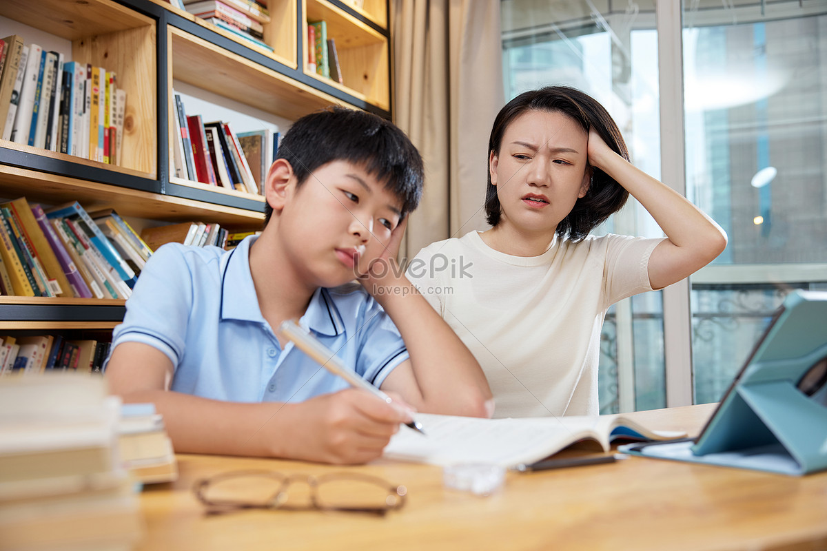 Mother helps her son with homework and has a headache, maternal love, student, sensible HD Photo