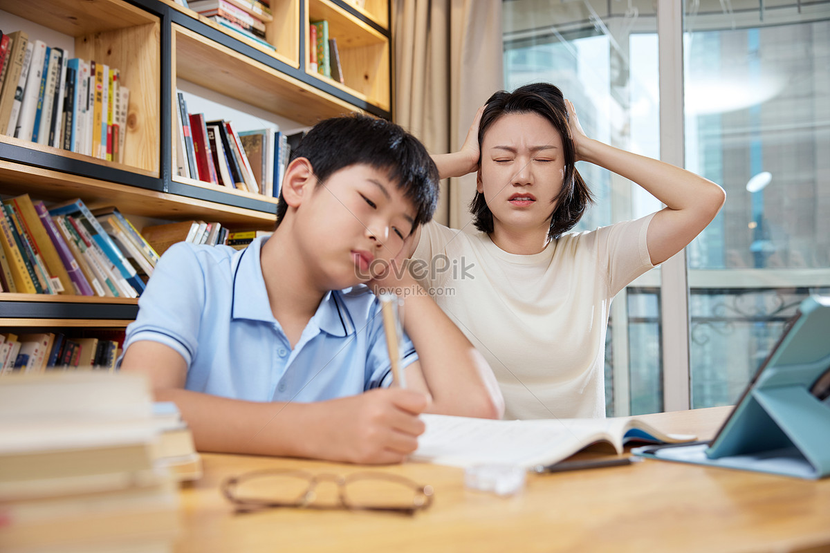 Mother has a headache while tutoring her child with homework at home, maternal love, student, sensible HD Photo