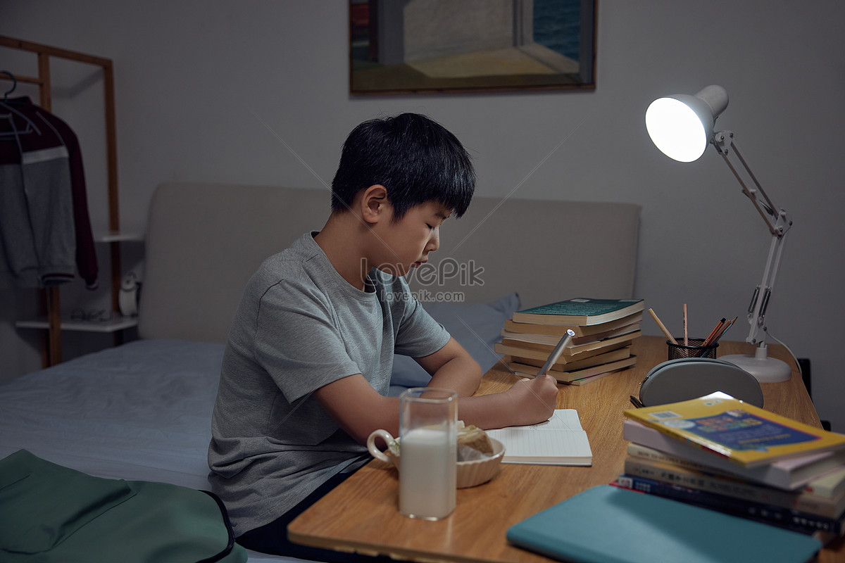 boy doing homework late at night Photo